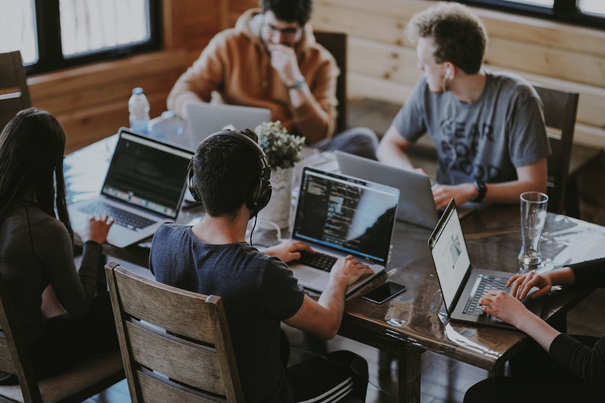 People gathered around a table together — addiction develops inside a system of family, work, and social roles