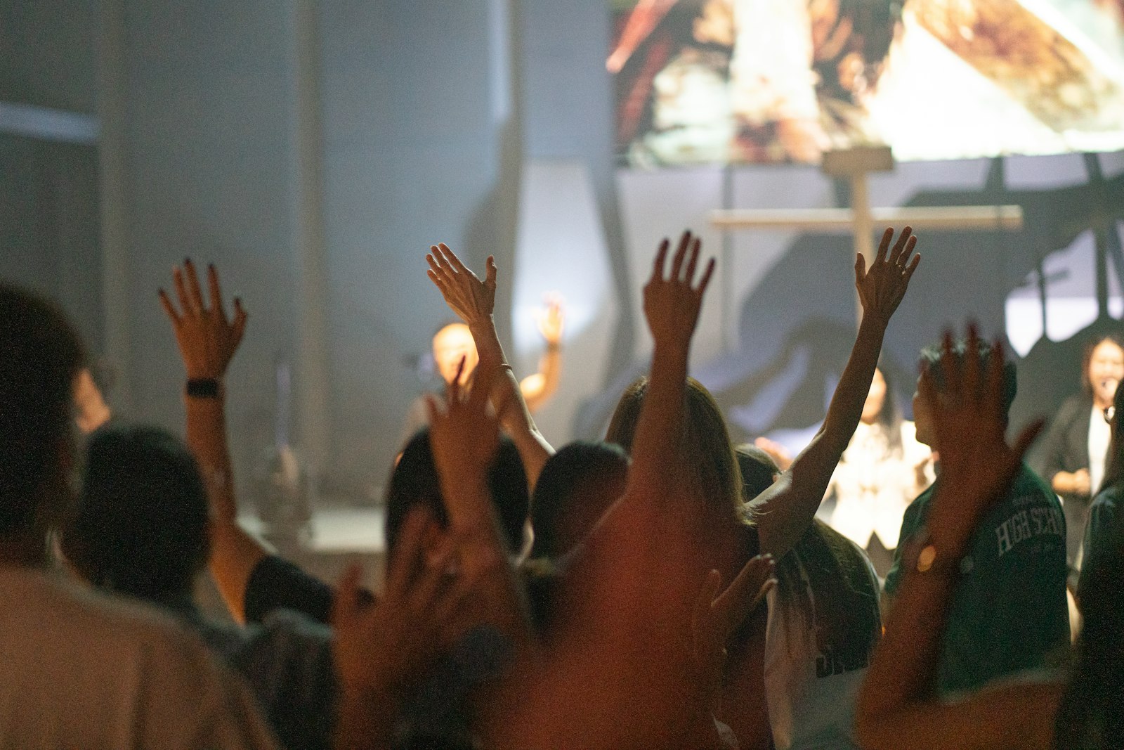 Hands raised in worship — faith is woven into recovery from the beginning, not added on at the end
