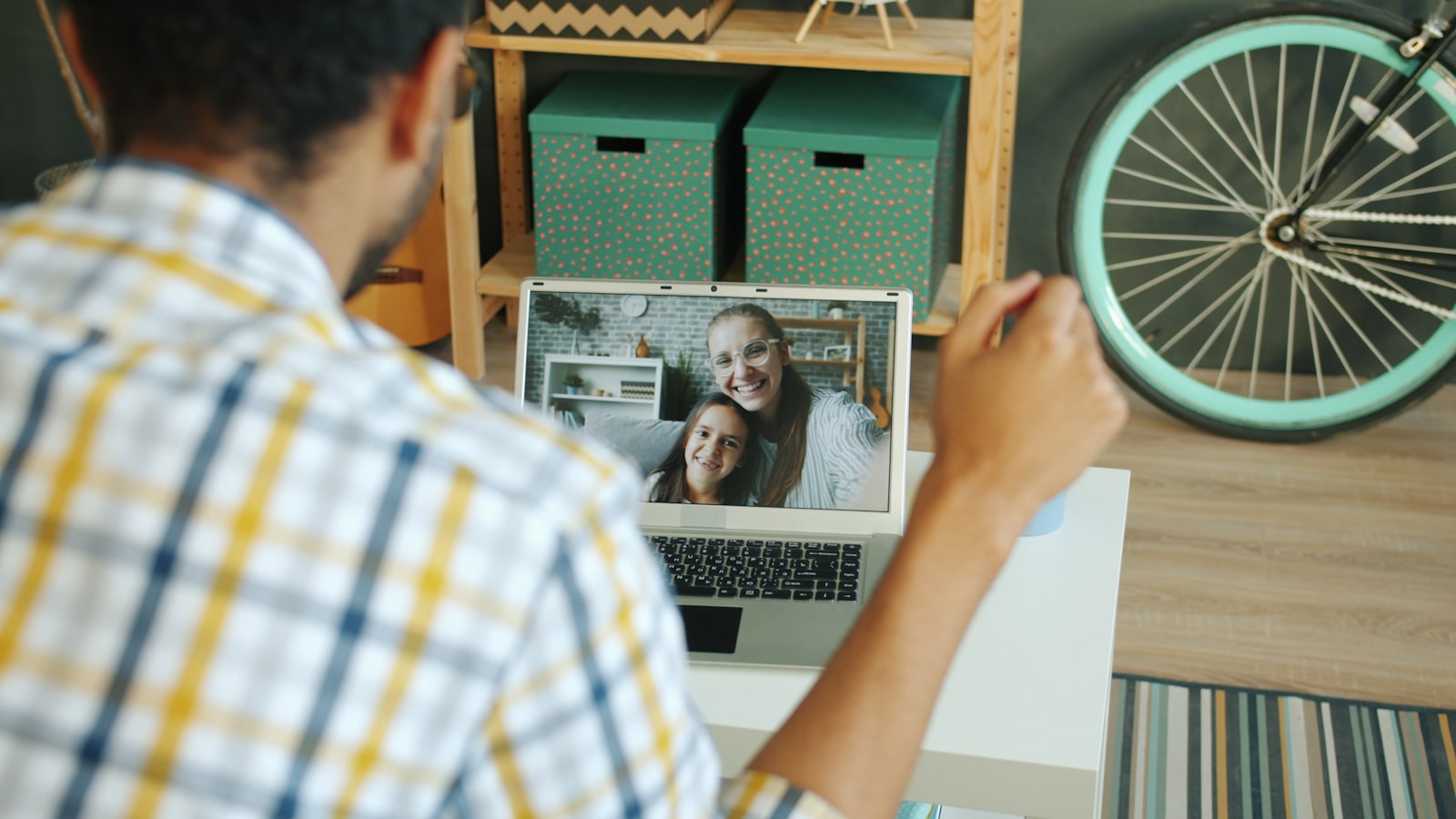 A man on a video call with his wife and child — staying connected to family is easy from Cozumel