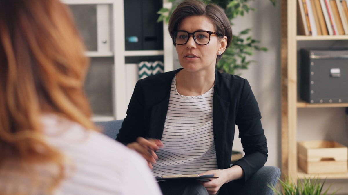 A licensed therapist in conversation with a client — clinical therapy and spiritual support working together alongside medical detox