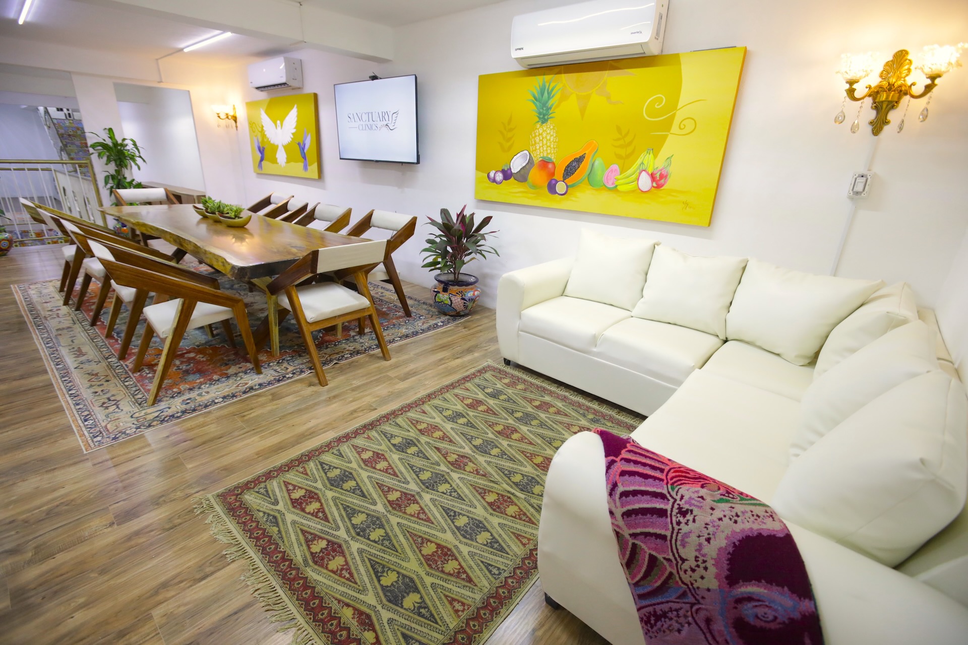 A warm, light-filled common room at the Sanctuary Clinics Cozumel residence — a home-like setting for connection